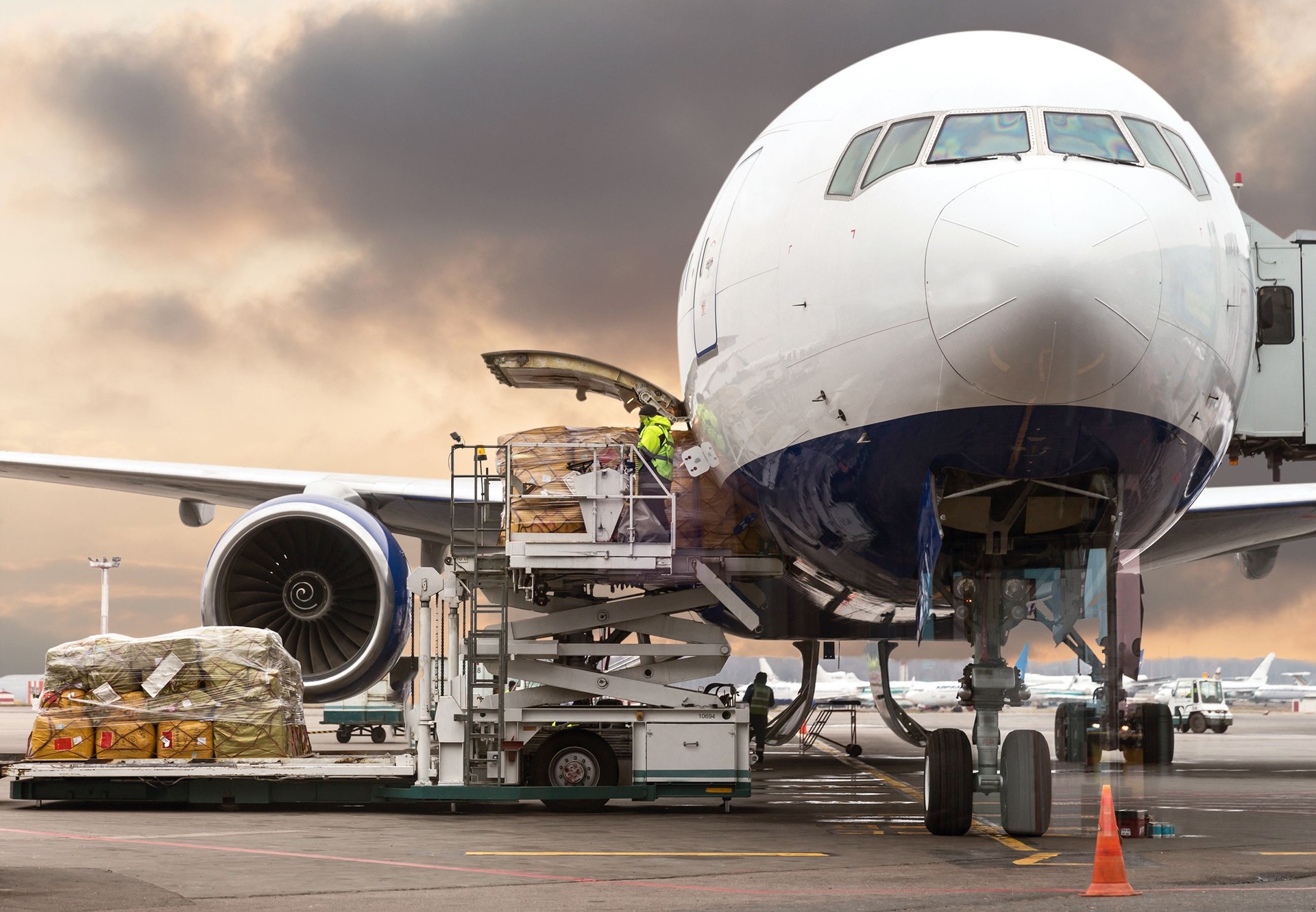 loading cargo into the aircraft before departure with nice sky